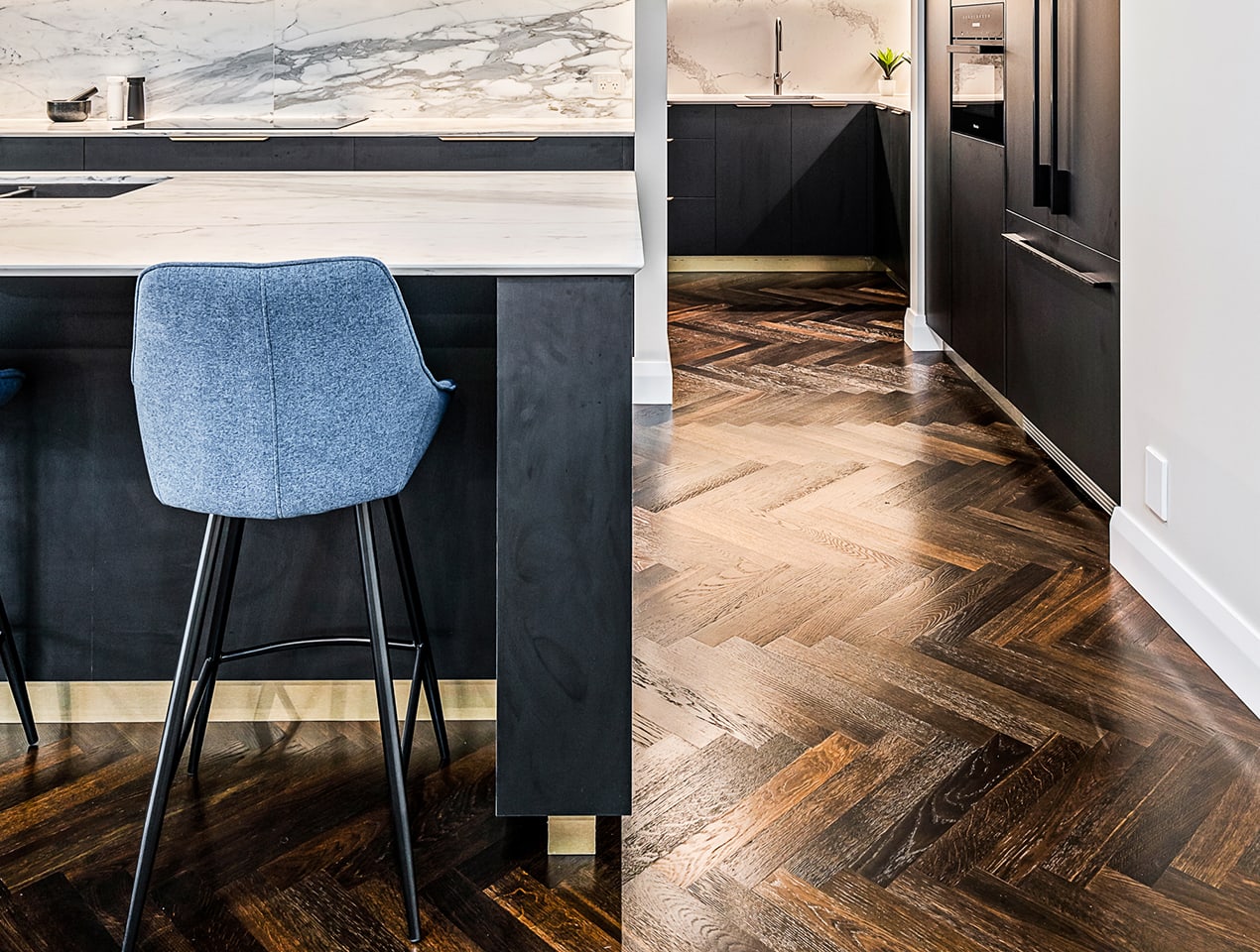 Bella Vista Buildcraft Display Home kitchen featuring Havwoods Notte Herringbone timber flooring.